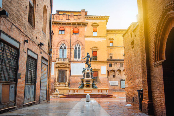 Neptune fountain Bologna, Italy - medieval bricks town with archs. Sunrise moment  - Photo, Image