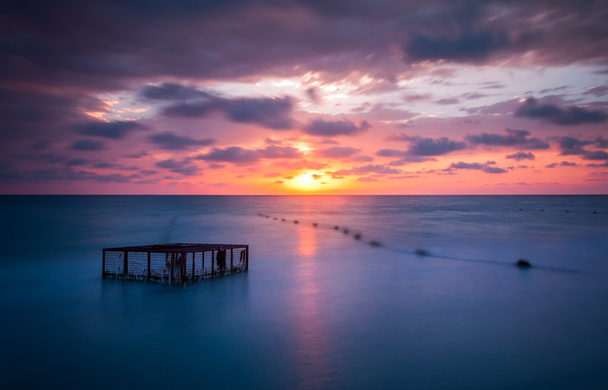 Seascape and Empty Cage at Colorful Sunset - Photo, Image