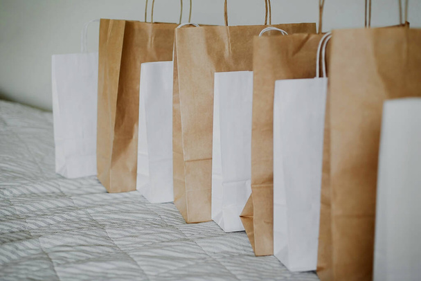 Brown and white Empty Kraft Paper Bags on fabric background. Packaging template mockup. - Fotografie, Obrázek