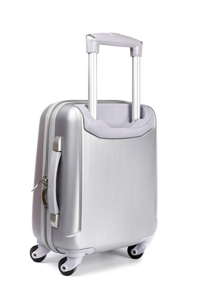 Trip isolated. Silver travel plastic suitcase or vacation baggage bag on white background. Design of summer vacation holiday concept - Photo, image