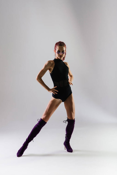 Σέξι κοκκινομάλλα χορεύτρια που δείχνει το σώμα της - Φωτογραφία, εικόνα