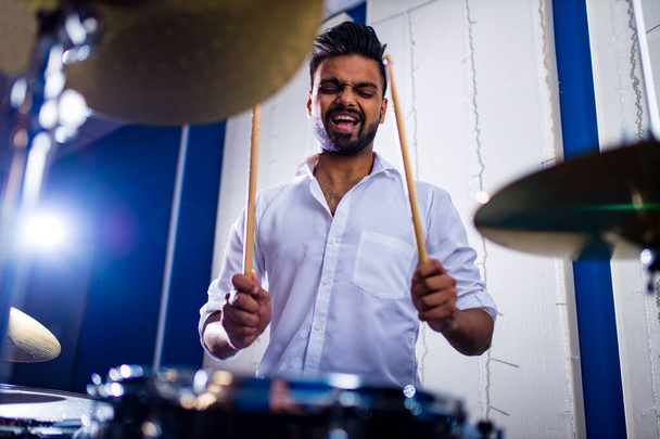 Attractive Teenage Drummer with Drumsticks in recording studio - Fotografie, Obrázek