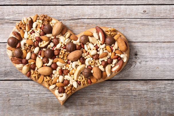 Mix of nuts . Healthy vegetarian food background . Love heart - 写真・画像