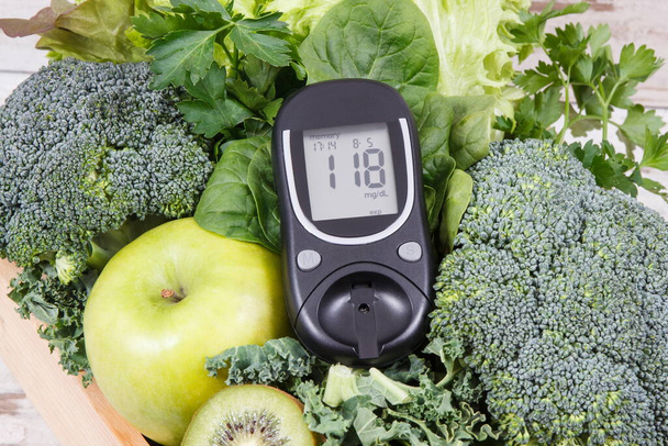 Glucometer with result of sugar level and green natural fruits with vegetables. Body detox and healthy nutrition during diabetes concept - Fotoğraf, Görsel