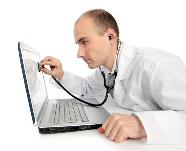 Doctor with stethoscope fixing laptop - Photo, Image