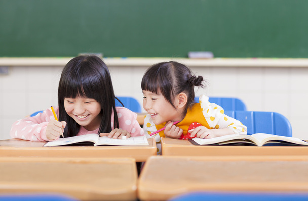 cute little student  look her classmate homework - Photo, Image