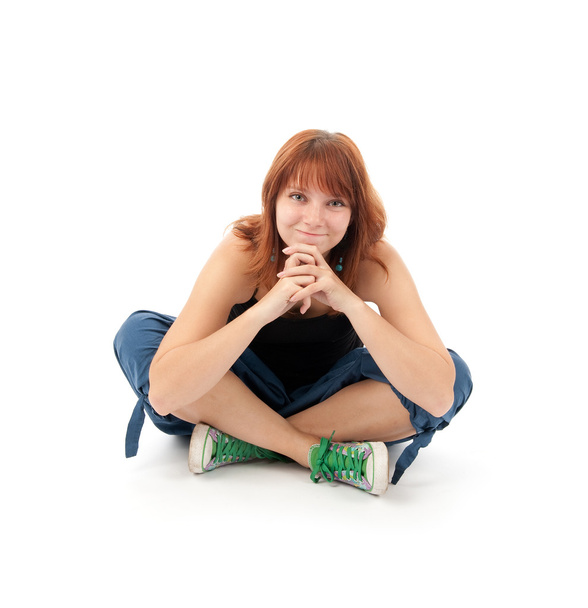 Happy young female sitting relaxed on the floor - Фото, изображение