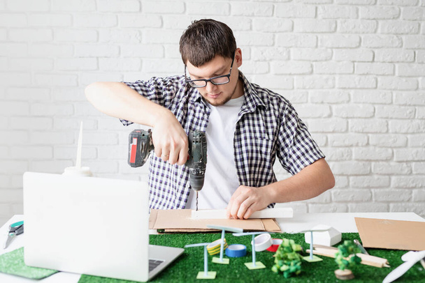 Young man teaching online making renewable energy dummy - Photo, Image