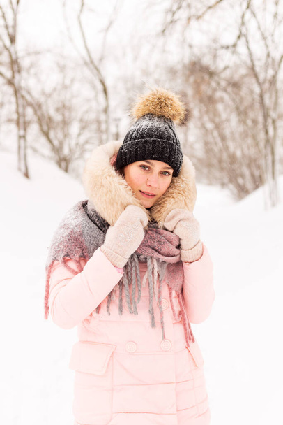 Young girl in a snowy forest in winter. - Фото, изображение
