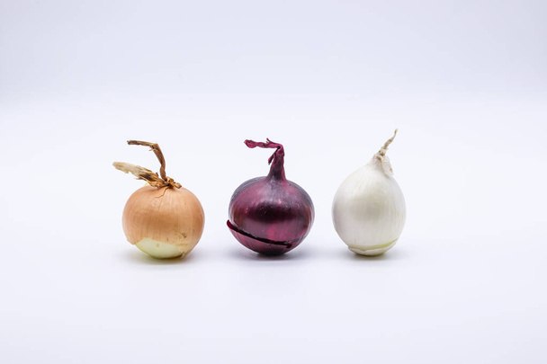 Three multy colored onions on white background  - Фото, изображение