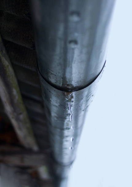 Melting icicles hanging on drainpipe close up - Photo, Image
