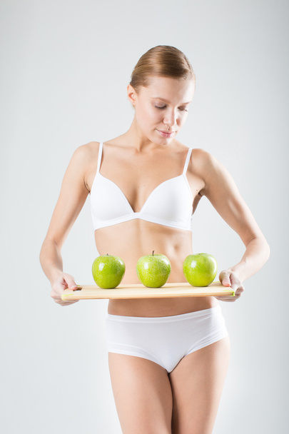 young slim girl holding a green apple - Foto, imagen