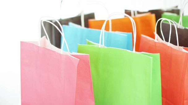 Colorful paper bags with purchases or presents, black friday or seasonal sale concept - Valokuva, kuva