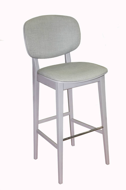Gray wooden bar stool with soft padding on white background. Interior element - 写真・画像