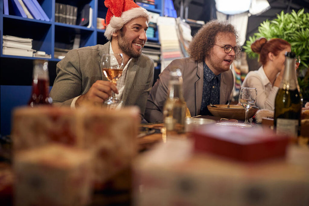 Employees having fun on a company's end of year dinner party - 写真・画像