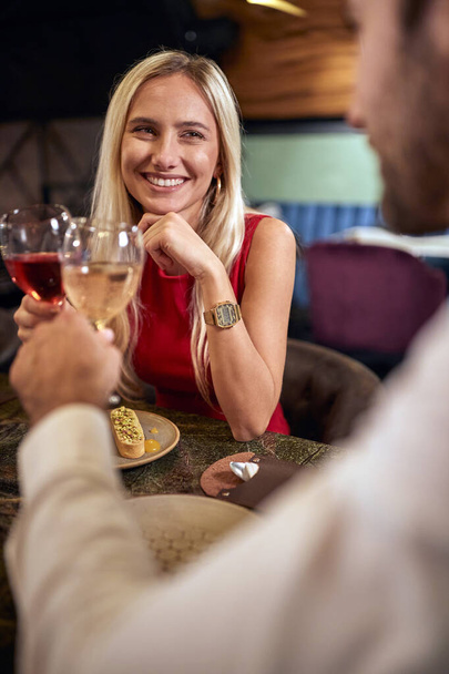 Cheerful couple on a romantic dinner date together - 写真・画像