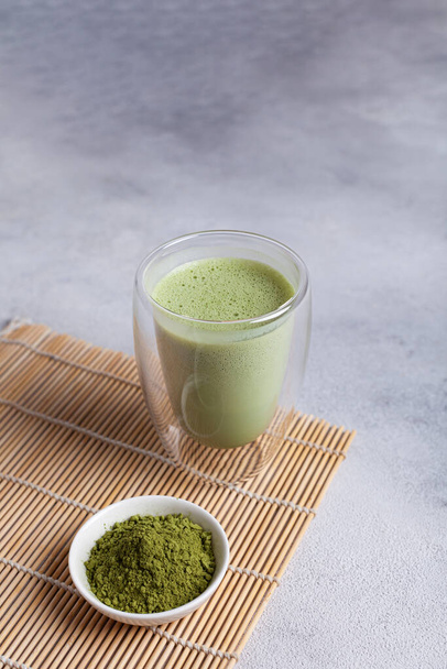 Matcha with milk in a glass on a light background - Photo, image