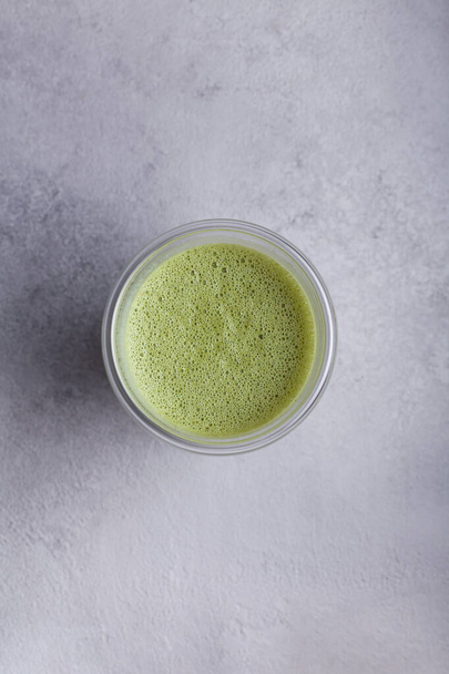 Matcha with milk in a glass on a light background - Foto, Bild