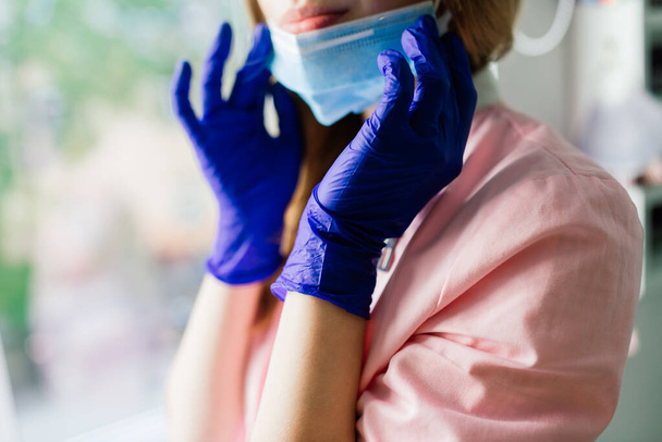 Beautiful female medical worker or manicure master in medical mask - 写真・画像