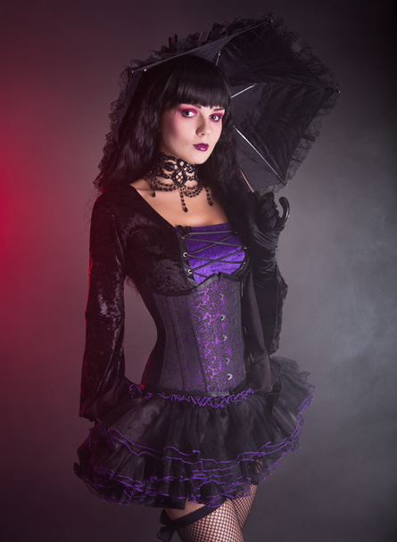 Beautiful girl in purple and black gothic Victorian outfit    - Foto, Imagen