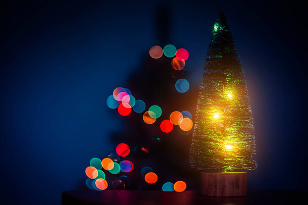 Christmas tree on the background of bokeh lights . Christmas tree. Lights bokeh defocus. New year and Christmas holidays. Holiday article. Copy space - Photo, Image