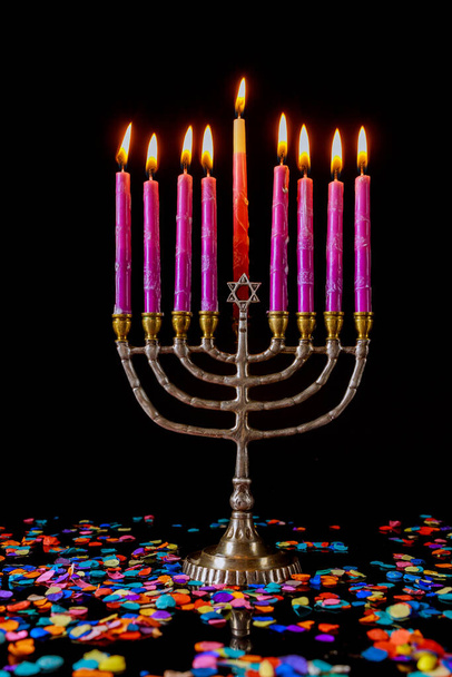 Vertical menorah with pink burning candles and confetti for Hanukkah jewish holiday. - Valokuva, kuva