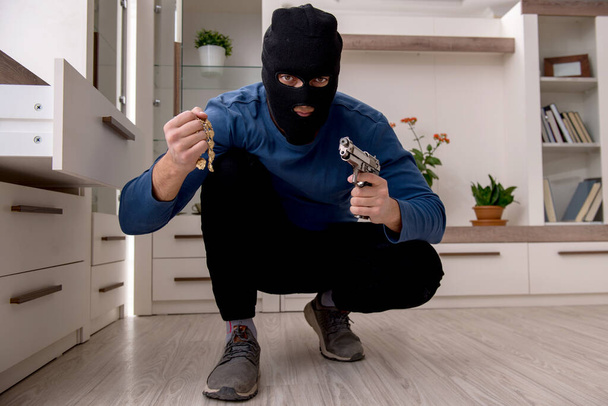 Male robber stealing valuable things from the house - Photo, Image