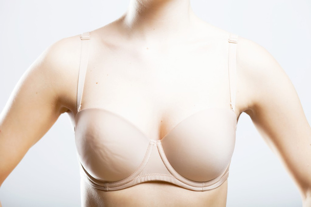 Skin-colored bra, breast of young woman - Photo, Image