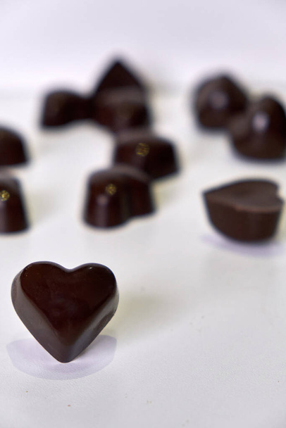 semi-sweet chocolate and milk chocolate chocolates filled with coconut milk, shaped like hearts - Fotografie, Obrázek