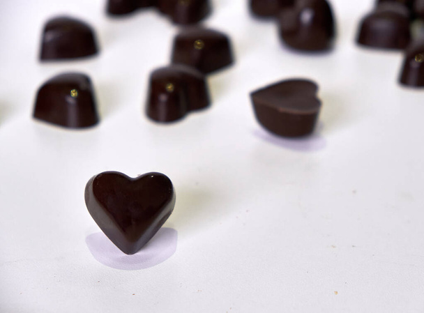 semi-sweet chocolate and milk chocolate chocolates filled with coconut milk, shaped like hearts - Zdjęcie, obraz
