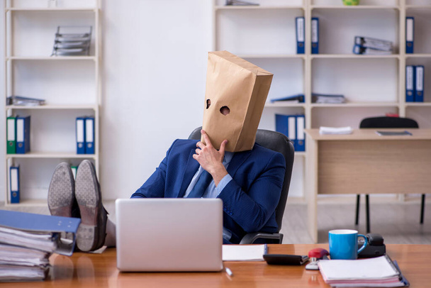 Young male employee with box instead of his head - Photo, Image