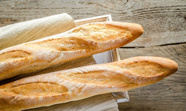 Two baguettes on the wooden tray - Photo, Image