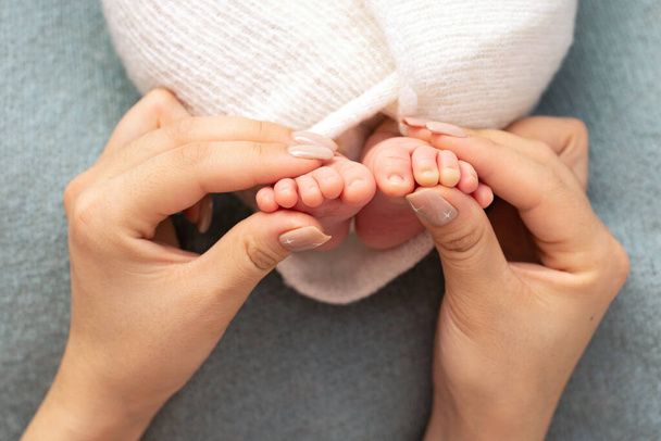 Newborn baby feet. Motherhood concept. Mother day. Copy space. Newborn baby feet. Motherhood concept. Mother day. Copy space. Selective focus - Photo, Image