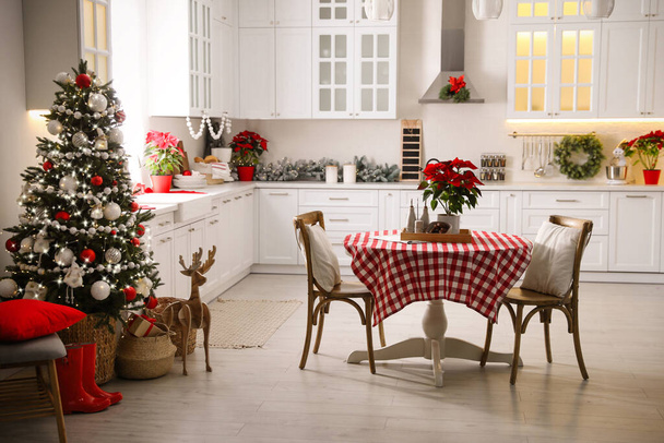 Beautiful kitchen interior with Christmas tree and festive decor - Valokuva, kuva