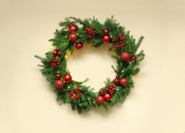 Beautiful Christmas wreath with festive decor on beige background, top view - Zdjęcie, obraz