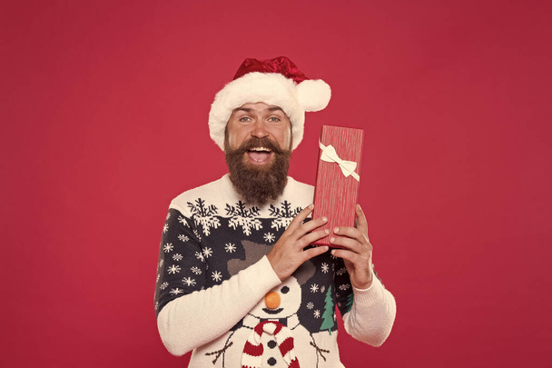 Christmas gift concept. Man celebrate winter holiday. Hipster in winter sweater. Winter season holidays. Box in his hands. Santa gave me present. Joyful shopping. Favorite tradition. Happy new year - Photo, Image