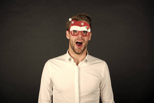 corporate party concept. business office party celebration. surprised handsome man party glasses. santa come for xmas. merry christmas. happy new year. businessman in funny santa claus glasses - Foto, afbeelding