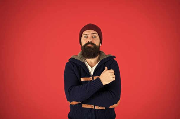Winter warmness. take care of beard hair in cold weather. autumn and winter collection. brutal hipster in hat. scared bearded man in knitted jacket. you need to dress warmly. male winter fashion - Foto, afbeelding