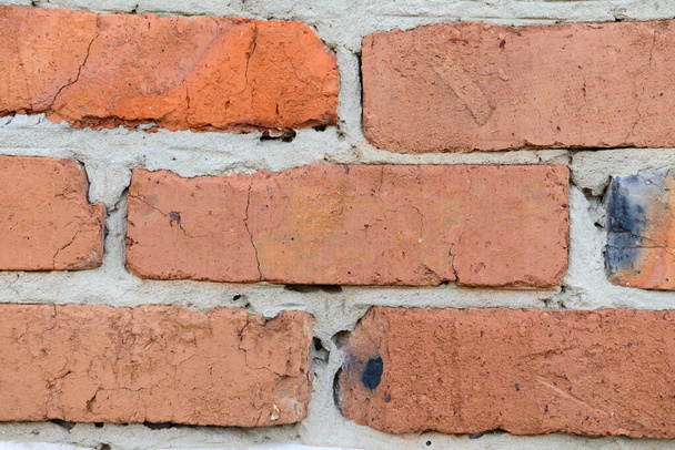 part of the building's wall is made of old red brick - Photo, Image