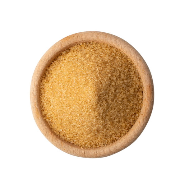 Top view eco bio brown sugar in wooden bowl isolated on white background. Raw unrefined organic cane sugar pile - Photo, Image