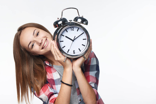 Portrait of smiling teen girl holding big clock - Fotografie, Obrázek