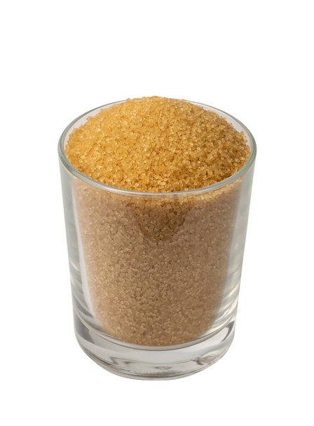 Eco bio brown sugar in glass isolated on white background with clipping path. Raw unrefined organic cane sugar pile side view - Photo, Image
