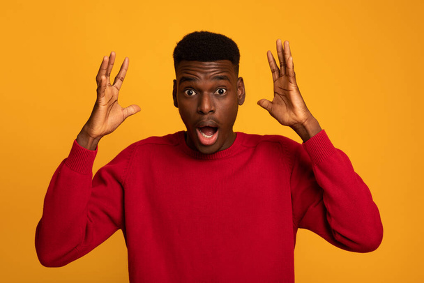 Portraif Of Shocked African American Guy Raising Hands In Excitement, Yellow Background - Photo, image