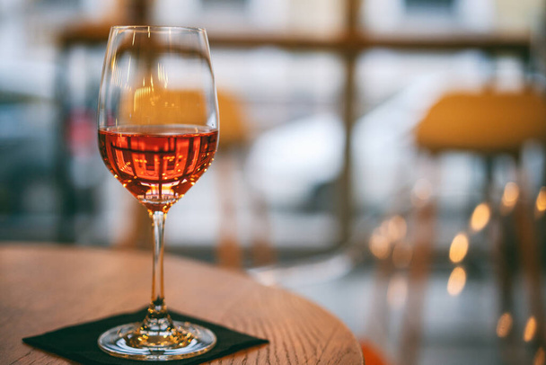 One glass of rose wine on a table in a cafe - Fotoğraf, Görsel