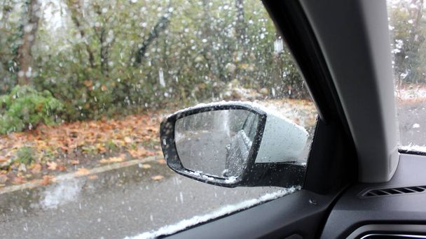Rearview mirror of the car - driving during a snowfall in the countryside - Photo, Image