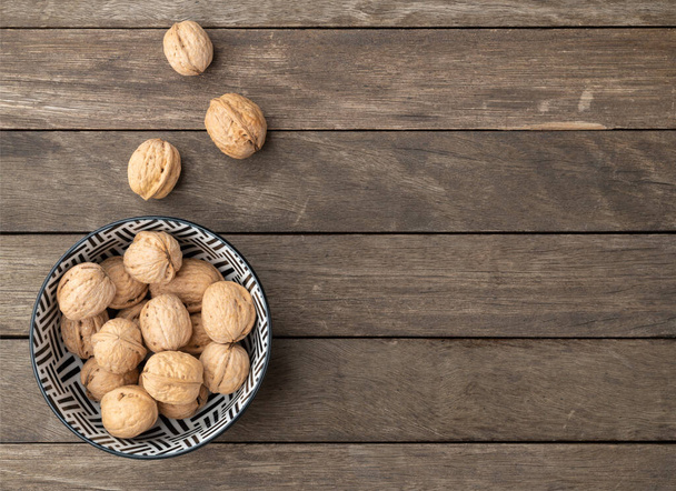 Walnuts over a wooden table with copy space. - Photo, Image