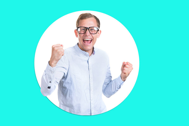 Portrait of happy young man in glasses an shirt on light green background. Male student is good mood, emotion cheerful and success. - Foto, imagen