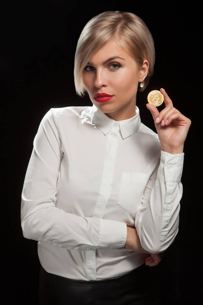 Woman holding physical bitcoin cryptocurrency coin in her hand. - Zdjęcie, obraz
