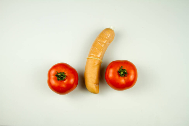 condom being put on a sausage as a representation of sex teaching - Foto, Imagen