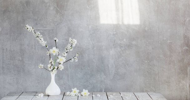 cherry flowers in white vase on background old gray wall - Photo, Image